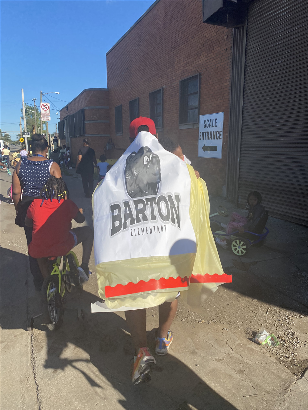  Barton parent wearing banner as cap at bike stroll